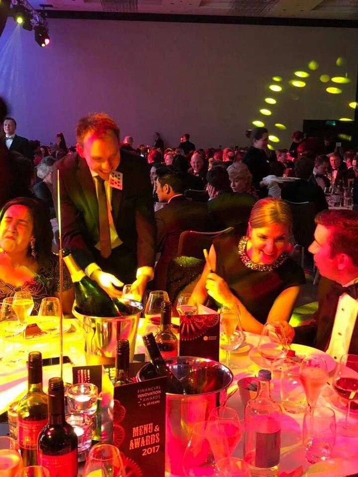 Neil performing between tables at an awards dinner