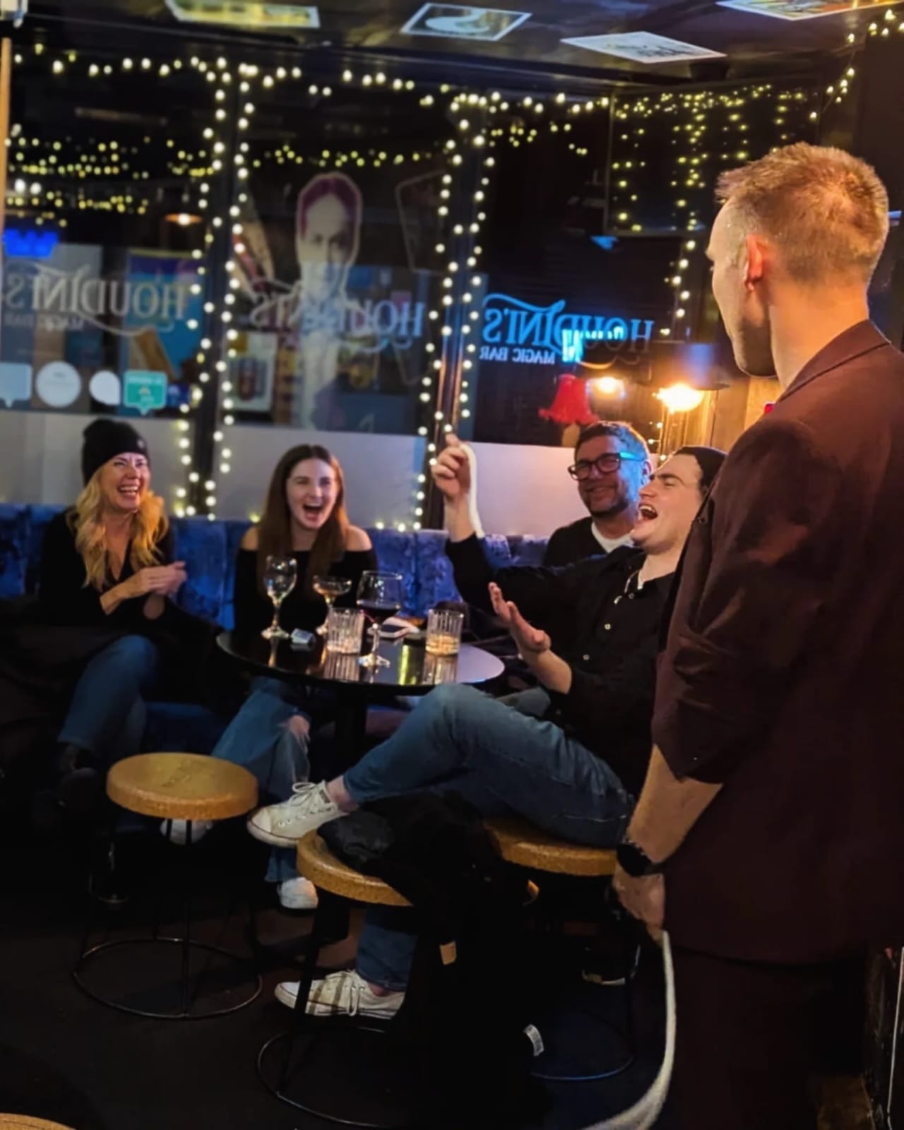 Guests around a table reacting to a close-up routine