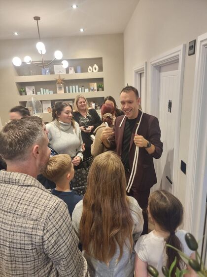 Families watching a rope trick at a party