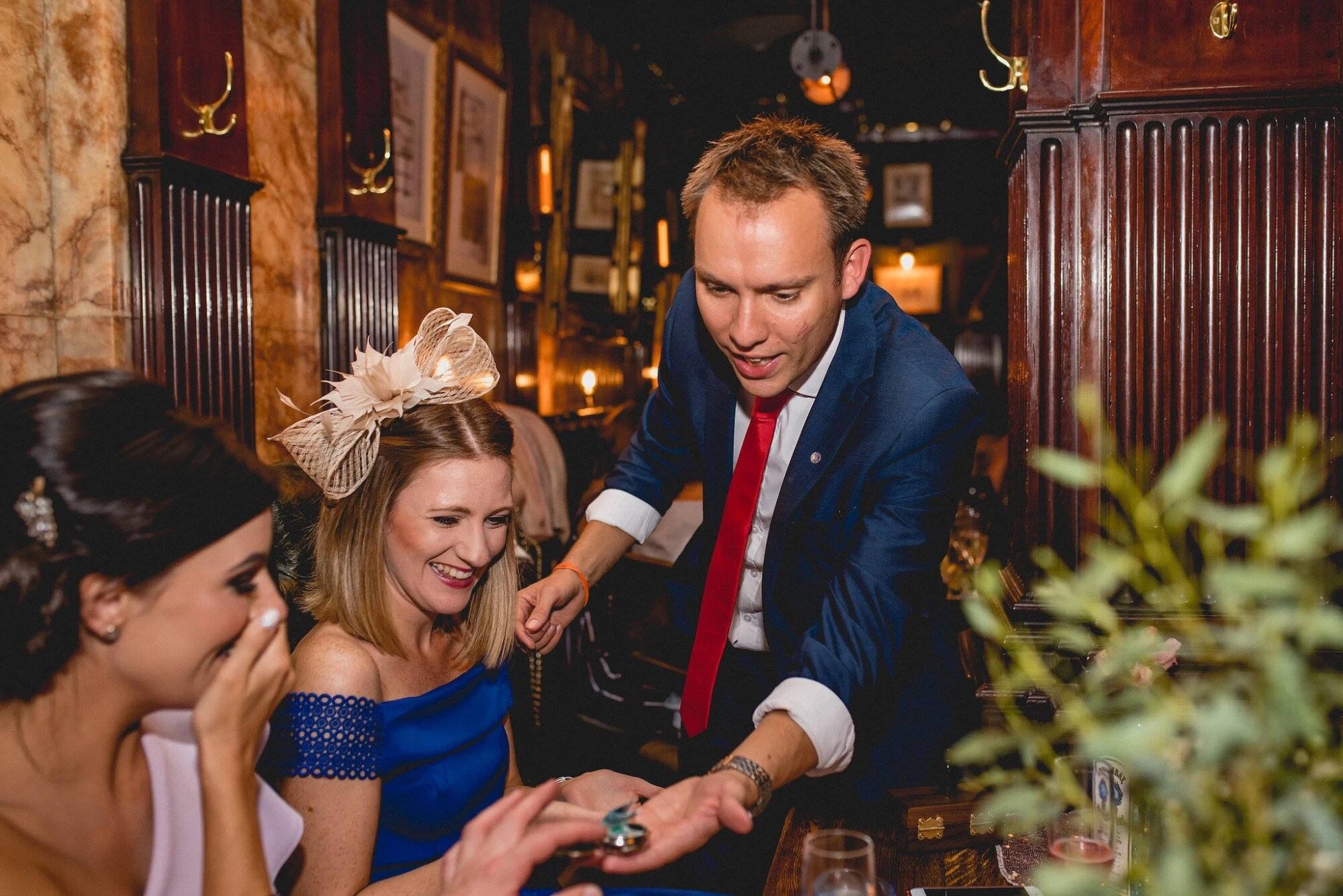 Neil revealing a ring to a delighted wedding guest